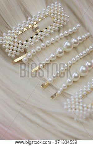 Pearl Hair Clips On Blond Hair Close-up. Hair Accessories. Hairpin With Pearls On A Bright Pink Back