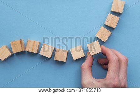 Hand Choosing A Wooden Block From A Set. Business Choice Concept