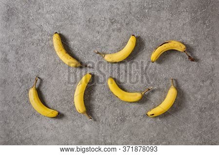 Ripe Bananas On Gray Concrete Background. Interior Photo. Photoart.