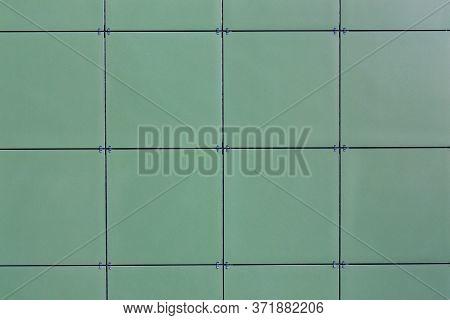 Texture Of The Wall Of A Modern Building With A Ventilated Facade. Green Ceramic Composite Facade Pa