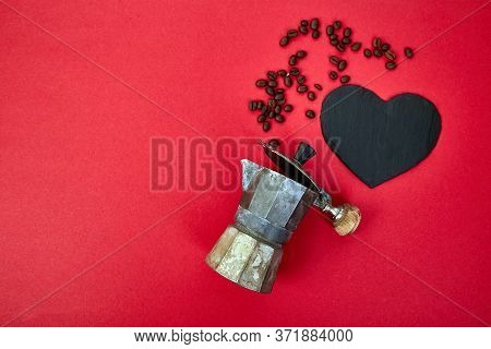 Flat Lay Of Coffee Maker And Coffee Beans On Red Background.