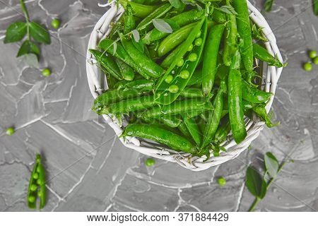 White Basket With Fresh Green Peas On Grey Background.