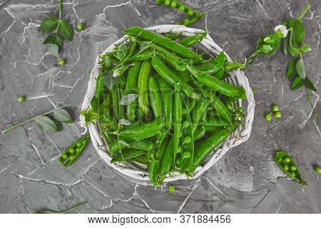 White Basket With Fresh Green Peas On Grey Background.
