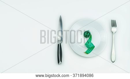 Tape Measure On Plate Remind You Of Proper Nutrition And A Beautiful Figure.