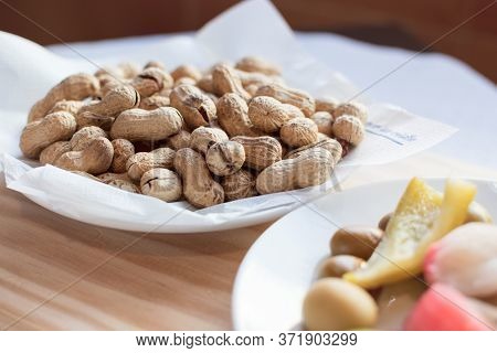 Olives Pepper And Peanuts On A Plate