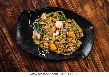 Top View On Spinach Fettuccine Pasta With Beef And Vegetables On The Wooden Table, Horizontal