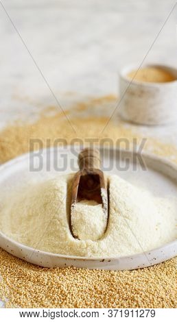 Plate Of Raw Amaranth Flour With A Scoop And Amaranth Seeds Close Up