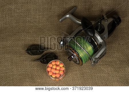 Fishing, Carp Reel With Fishing Linel On The Background Of Burlap . Burlap