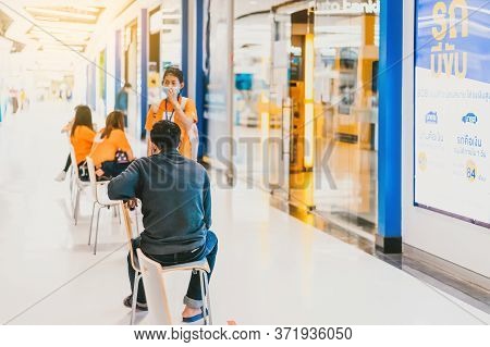 Kanchanaburi,thailand-may 16,2020:unidentified People Sit On Chair Were Spaced Apart And Waiting For