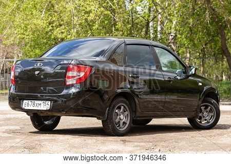 Novosibirsk/ Russia - May 02 2020: Black Lada Granta, Popular Sedan  Car Parked Outdoors On A Warm S