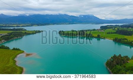 Aerial View Over Lake Forggensee At The City Of Fuessen In Bavaria Germany