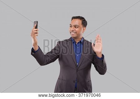 Businessman Having Video Call On Phone Waving Isolated. Indian Man Businessman Video Call. Business 