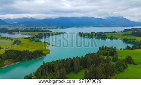 Aerial View Over Lake Forggensee At The City Of Fuessen In Bavaria Germany