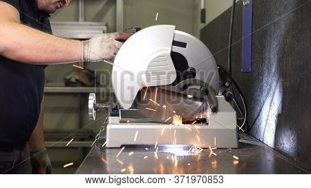 Iron Sawing Close Up. Hot Sparks At Grinding Metal.