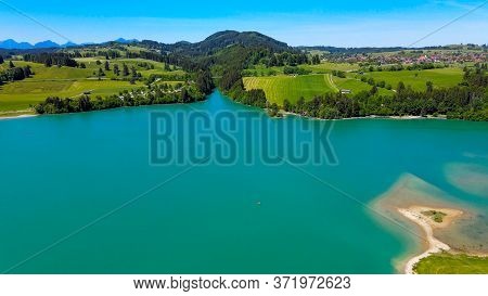Aerial View Over Lake Forggensee At The City Of Fuessen In Bavaria Germany