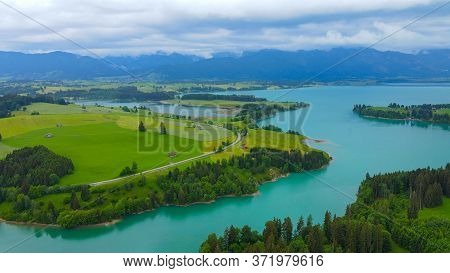 Aerial View Over Lake Forggensee At The City Of Fuessen In Bavaria Germany