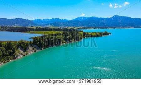 Aerial View Over Lake Forggensee At The City Of Fuessen In Bavaria Germany