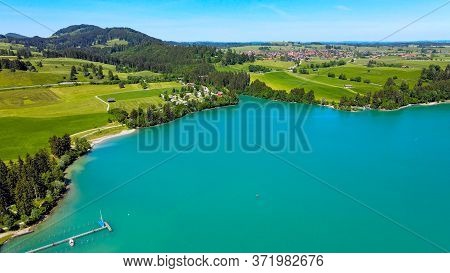 Aerial View Over Lake Forggensee At The City Of Fuessen In Bavaria Germany