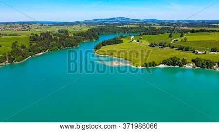 Aerial View Over Lake Forggensee At The City Of Fuessen In Bavaria Germany