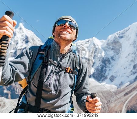 Portrait Of Smiling Hiker Man On Taboche 6495m And Cholatse 6440m Peaks Background With Trekking Pol