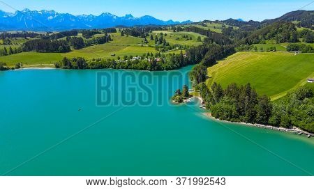 Aerial View Over Lake Forggensee At The City Of Fuessen In Bavaria Germany