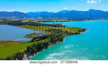 Aerial View Over Lake Forggensee At The City Of Fuessen In Bavaria Germany