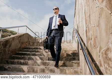 Confident Middle Age Businessman With Briefcase Walking Downstairs. Close-up Of Businessman Wearing 