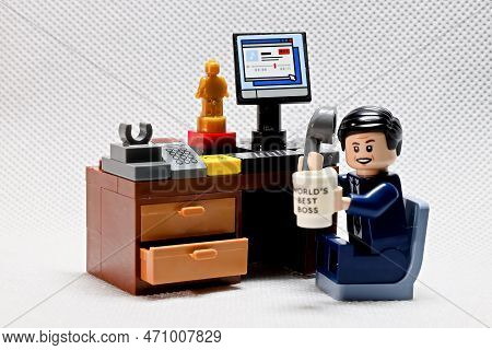 Osaka, Japan - February 19, 2023 Lego Businessman Sits At His Working Table With Computer, Trophy, C