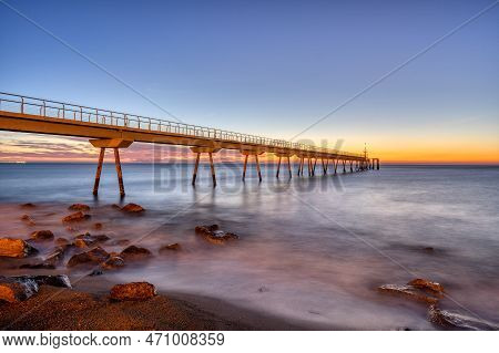 The Sea Pier Of Badalona, Known As Pont Del Petroli, Before Sunrise