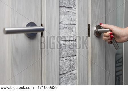 Woman Opens The Door To The Room. Woman Opens The Door. Hand Pressing The Doorknob. Woman Opens Toil