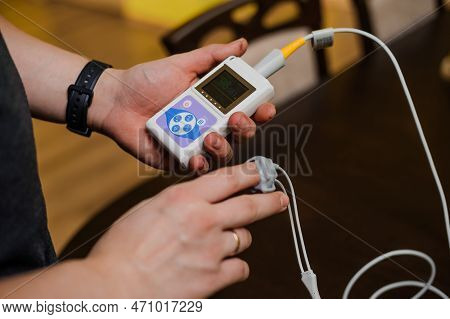 Man Using Pulse Oximeter Measures Oxygen Saturation Level, Health Care Monitoring Concept. Pulse Oxi