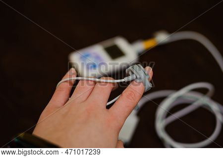 Man Using Pulse Oximeter Measures Oxygen Saturation Level, Health Care Monitoring Concept. Pulse Oxi