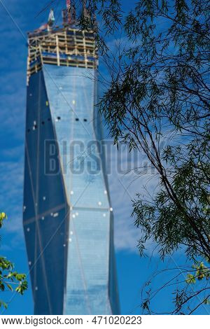 Kuala Lumpur, Malaysia - September 20, 2021 Trees With A Buildling In The Background. The New Iconic