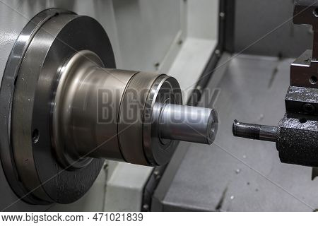The  Cnc Lathe Machine Boring  Cutting The Metal Shaft Parts. The Hi-technology Metal Working Proces