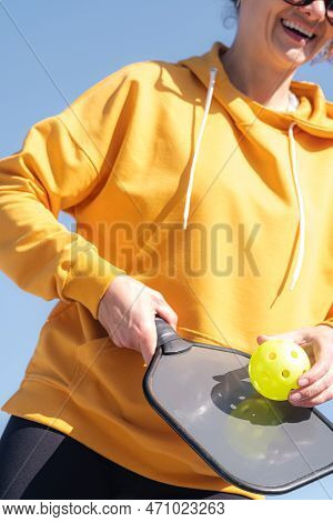 Pickleball Paddle And Yellow Ball Close Up, Woman Playing Pickleball Game, Hitting Pickleball Yellow