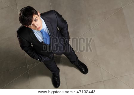 Image of young businessman looking above. Top view