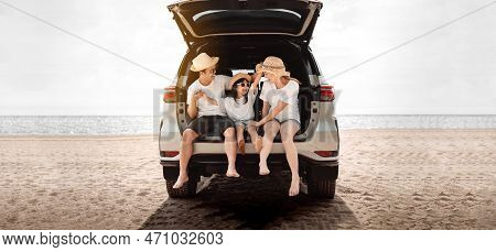 Family With Car Travel Driving Road Trip Summer Vacation In Car In The Sunset, Dad, Mom And Daughter
