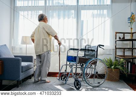 Asian Senior Old Man With Wheelchair Walking With Walker Cane Stick In Nursing Home, Elderly Mature 