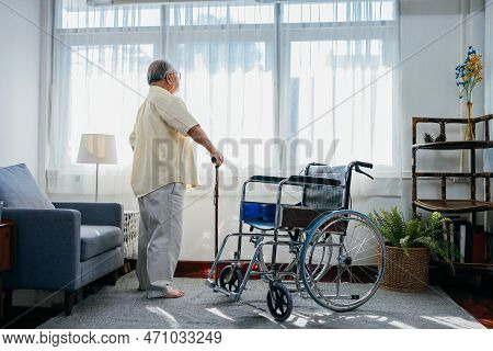 Asian Senior Old Man With Wheelchair Walking With Walker Cane Stick In Nursing Home, Elderly Mature 