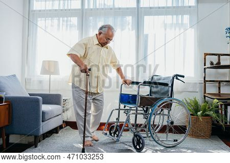 Asian Senior Old Man With Wheelchair Walking With Walker Cane Stick In Nursing Home, Elderly Mature 