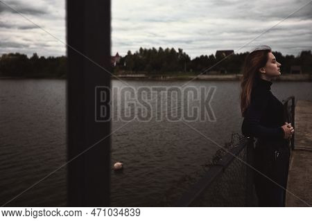 Young Lonely Teenage Girl Looks Into The Distance And Renunciated Alone With Herself Thinks And Is B