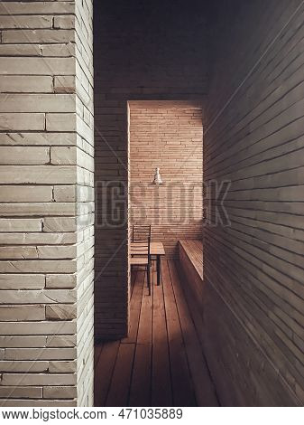 Natural Interior Of Rooms With Brick Walls And Wooden Floor. Minimalism. Wooden Furniture And Metal 
