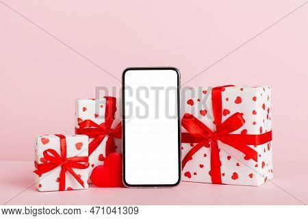 Mobile Phone With Blank Screen On Colored Background With Hearts, Calendar And Gift Box, Valentine D