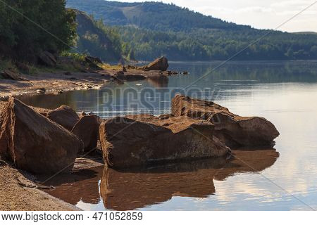 Lake Surrounded By Green Forest, Hill With Forest On Background.summer Day.large Rock In Water