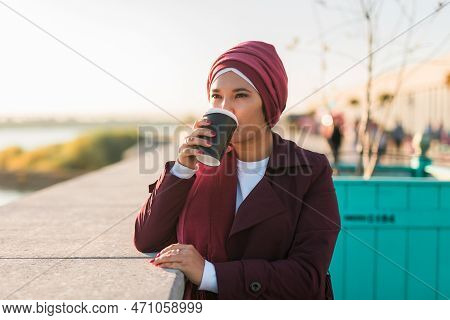 Portrait Arab Woman In Hijab Drinking Coffee In Cafe Outdoors, Copy Space And Empty Place For Advert