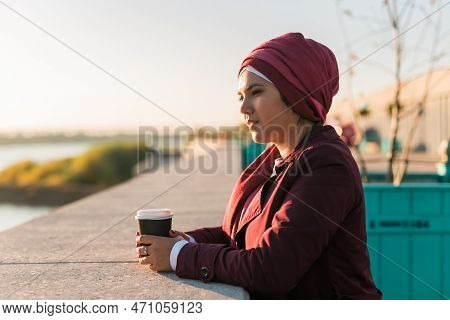 Portrait Arab Woman In Hijab Drinking Coffee In Cafe Outdoors, Copy Space And Empty Place For Advert