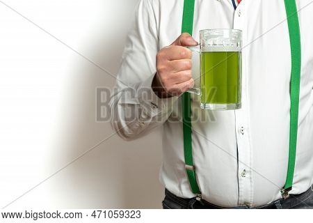 Unrecognizable Man With Suspenders Celebrates St. Patricks Day Drinking Beer. High Quality Photo