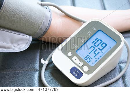 Man Check Blood Pressure Monitor And Heart Rate Monitor With Digital Pressure Gauge. Health Care And