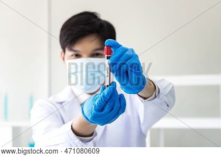 Scientist Man Holding Sample Blood Test Tube In Science Laboratory. Doctor Clinic Healthcare Technic