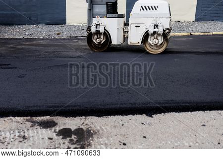Asphalt Skating Rink On The Street. Road Repair Concept.  Powerful Heavy Road Roller